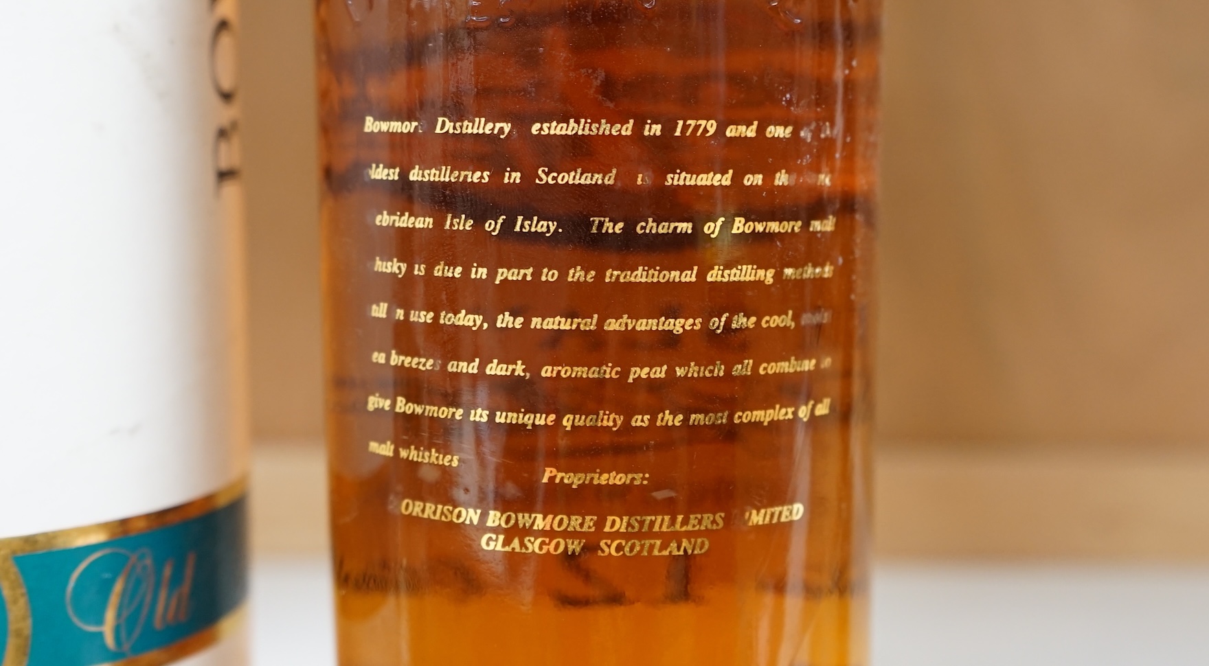A bottle of Bowmore 12 Year Old Islay Single Malt Scotch Whisky, 1980s screen print bottle, 43% vol 1 litre, in original cardboard tube. Condition - good.